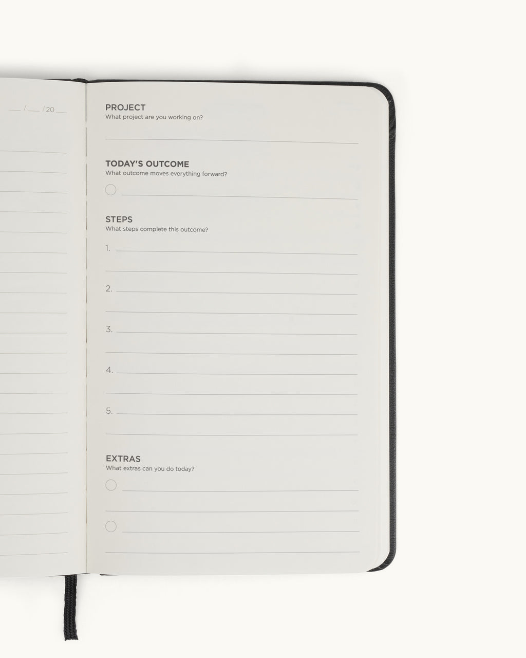 Open spread of the black Matine Daily Planner showing the “Project,” “Today’s Outcome,” “Steps,” and “Extras” page with numbered lines, check circles, and ribbon bookmark visible.