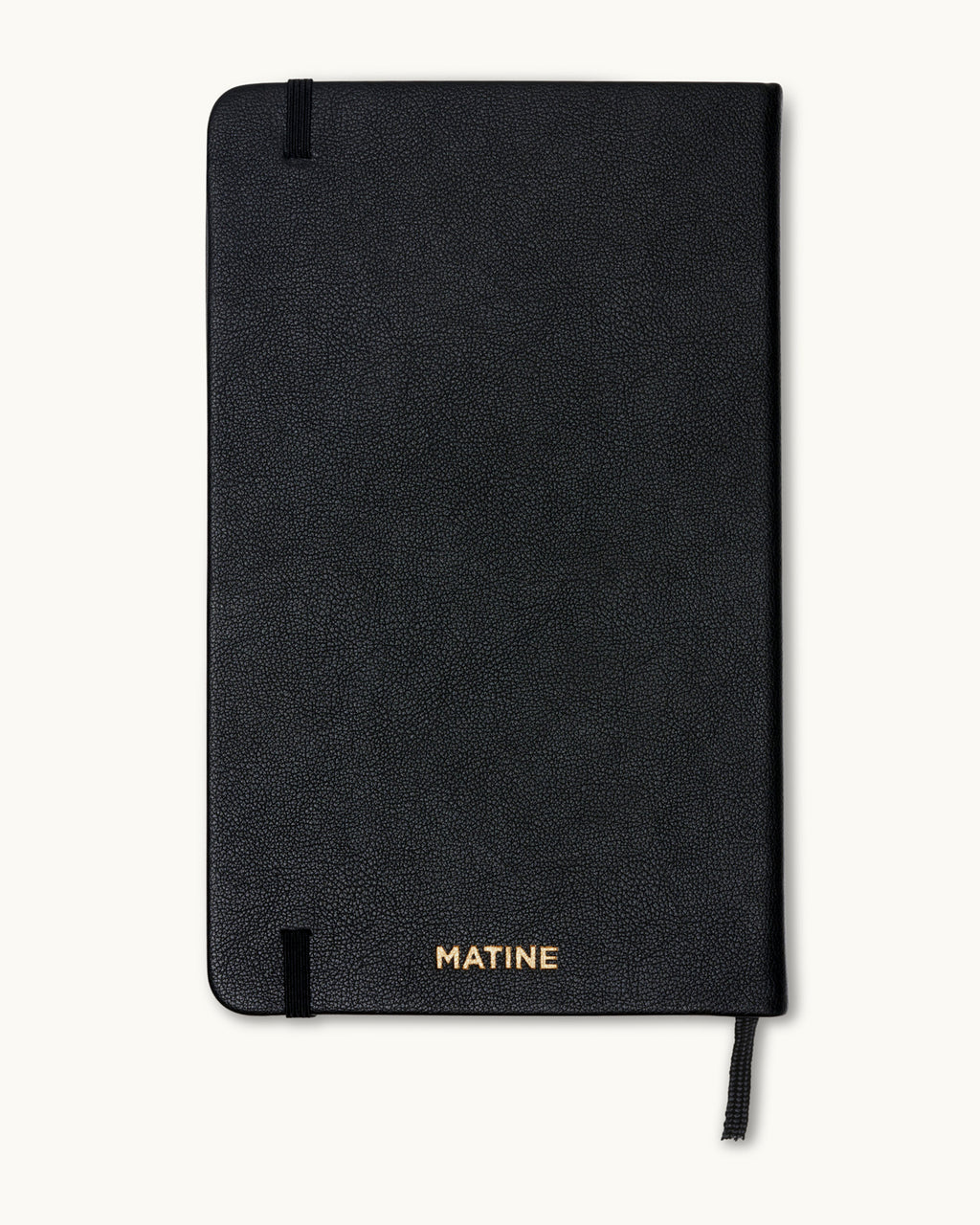 Back cover of black planner with gold-embossed Matine logo.