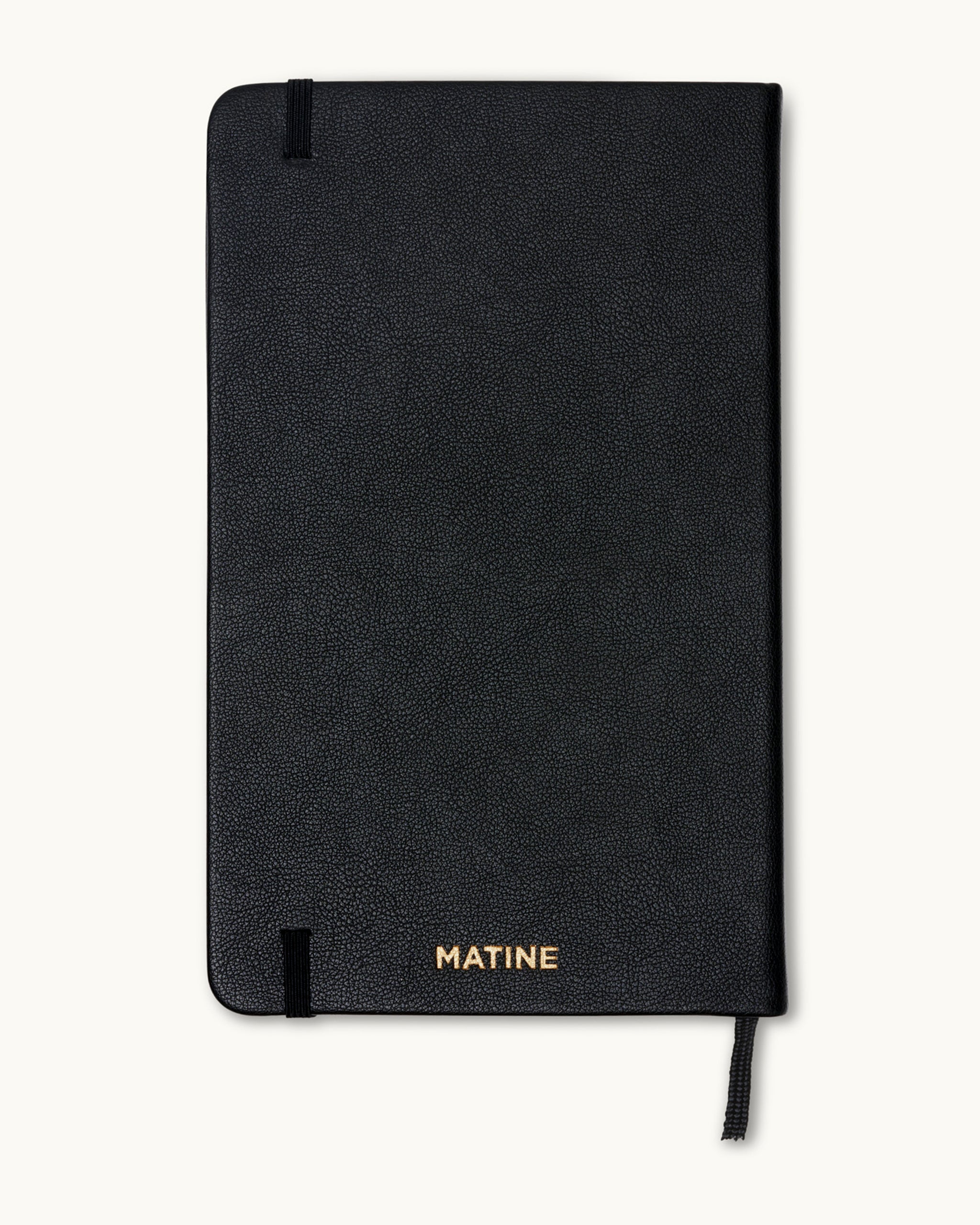 Back cover of black planner with gold-embossed Matine logo.